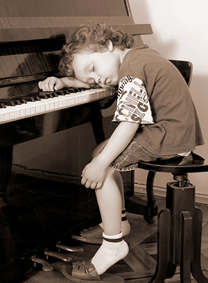 child asleep at piano