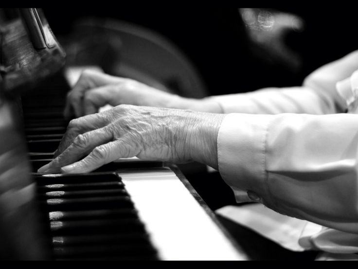 Elderly man's hands playing piano