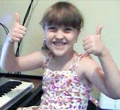 happy child at piano keyboard